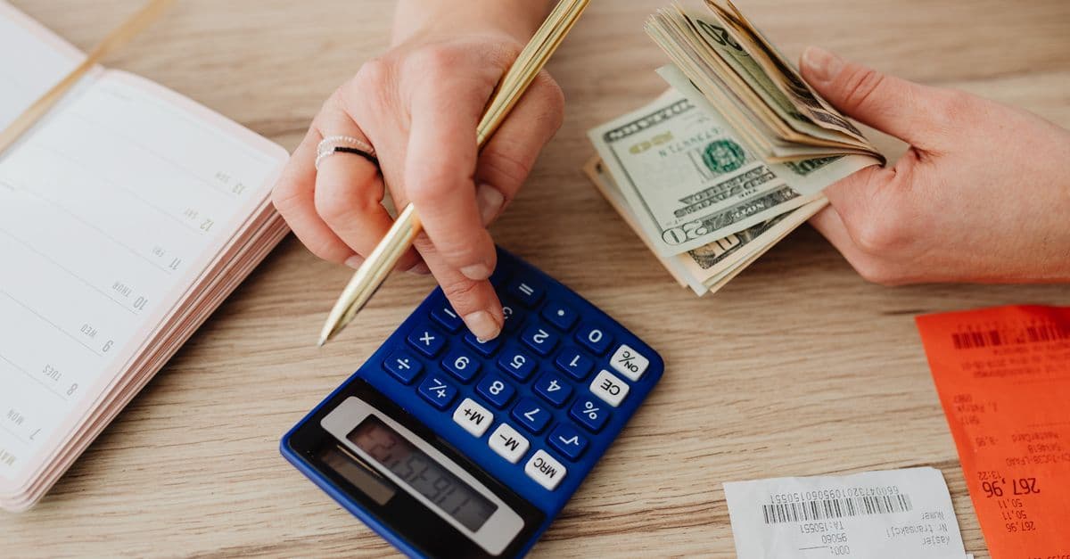 Hands working through a budget with a calculator