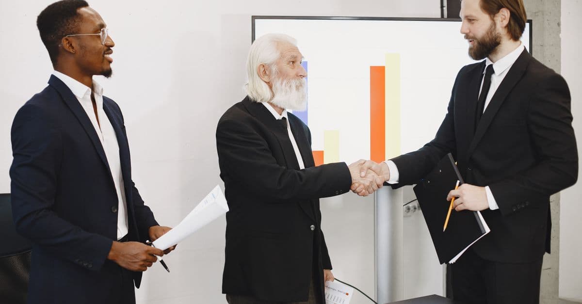 A sales team closing a deal with a handshake