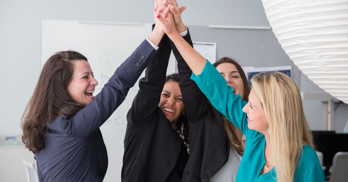 A team celebrating success with a high five